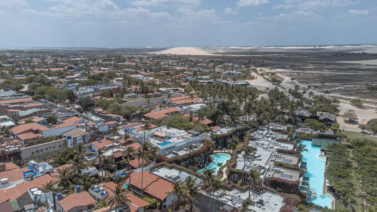 Aerial view of Jericoacoara village, its accommodation and the dunes beyond